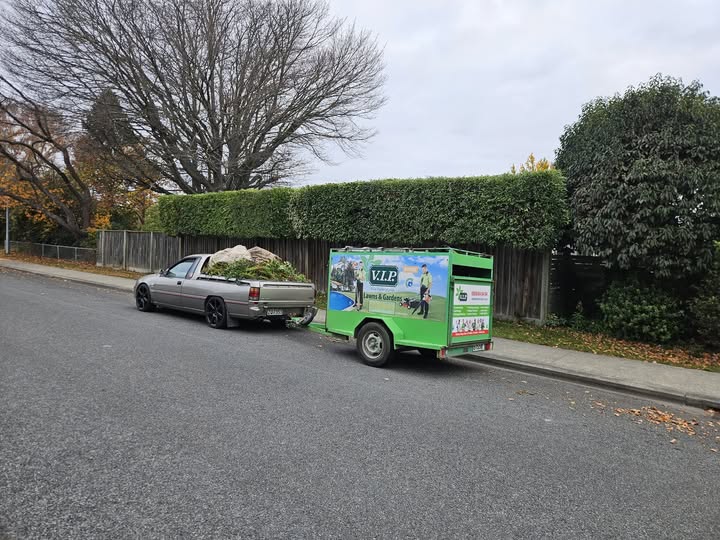 VIP Lawns and Gardens Rangiora branded trailer and ute on a Rangiora street after a garden clean-up